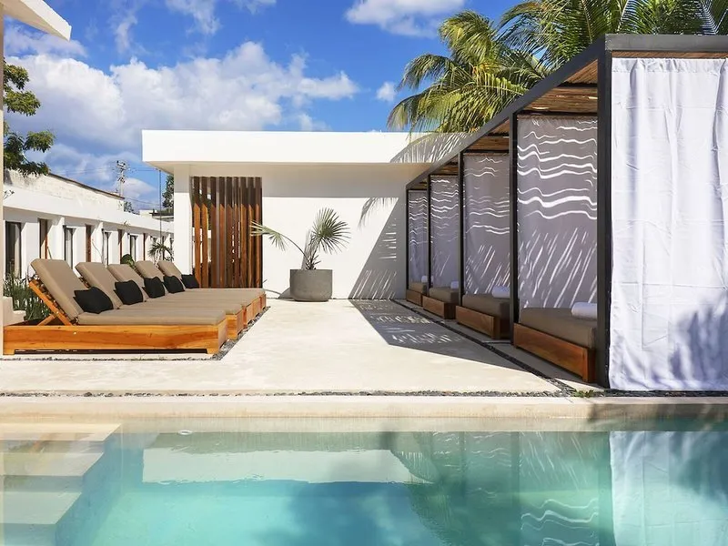 Zunanji bazen z modernimi ležalniki in kabanami